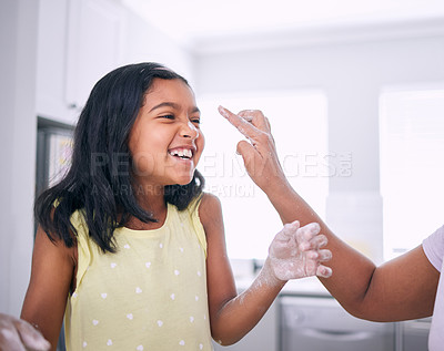 Buy stock photo Girl, mother and play with flour or nose touch in kitchen, baking and fun with ingredients in home. Daughter, mommy finger and bonding or help with cookies or cake prep, childhood and learning pastry