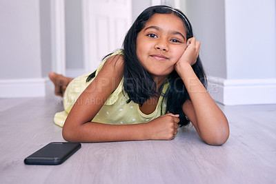 Buy stock photo Shot of an adorable little girl lying on the floor at home