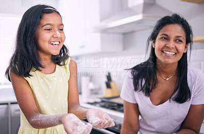 Buy stock photo Cropped shot of an adorable little girl baking at home with her mother