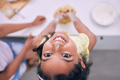 Buy stock photo Cropped shot of an adorable little girl baking at home with her mother