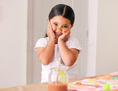 Buy stock photo Shot of an adorable little girl painting while sitting at a table