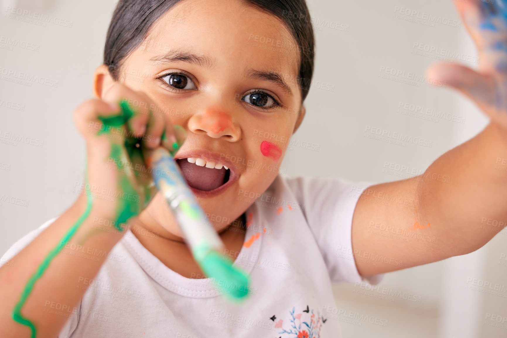 Buy stock photo Portrait, art and kid with paint on face, excited for learning and happy child development in home. Painting, drawing and color for creative kindergarten girl with brush, education and watercolor fun