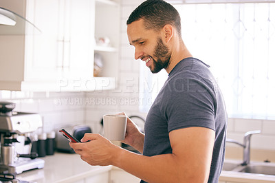 Buy stock photo Home, coffee and man with smartphone, typing and connection with internet and latte in kitchen. Person in house, mobile user or guy with morning tea or cappuccino with cellphone, text or social media
