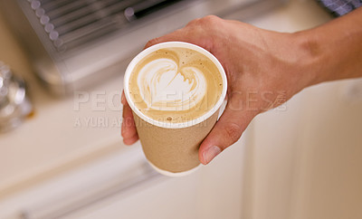 Buy stock photo Shot of an unrecognizable man holding a cup of coffee with coffee art