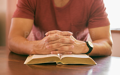 Buy stock photo Faith, praying and hands with man, bible and spiritual with religion or worship with guidance or scripture. Closeup, guy in home or peace with person or holy book with trust or gratitude with believe