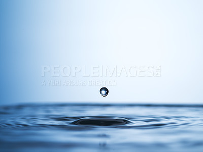 Buy stock photo Abstract studio shot of a water droplet falling into a puddle of water
