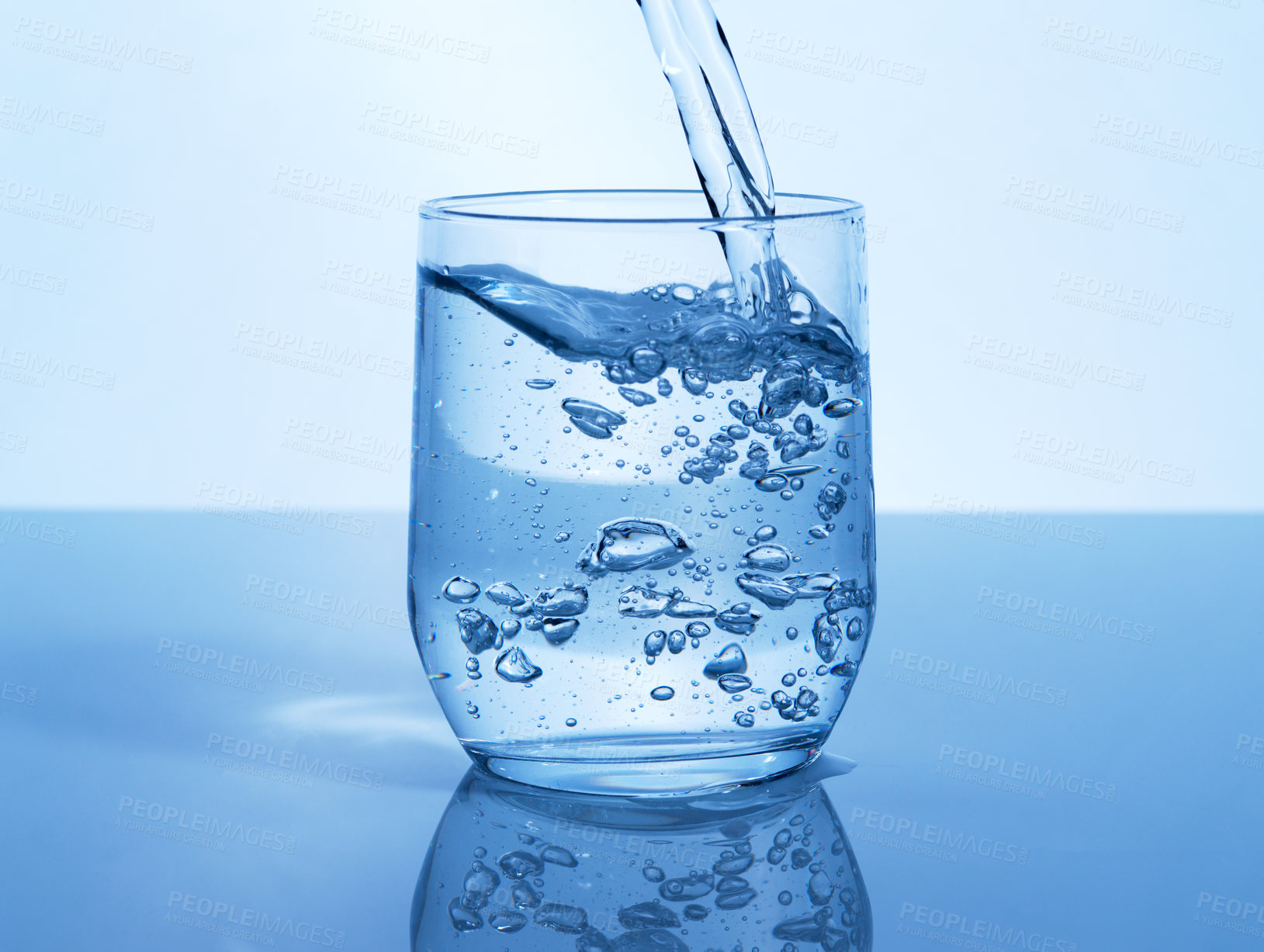 Buy stock photo Studio shot of a glass of water being poured in studio