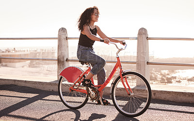 Buy stock photo Woman, cycling and bike at beach for travel with freedom, sea and sunshine with eco friendly journey in Los Angeles. Bicycle, exercise and adventure by the coast, carbon footprint and sustainability