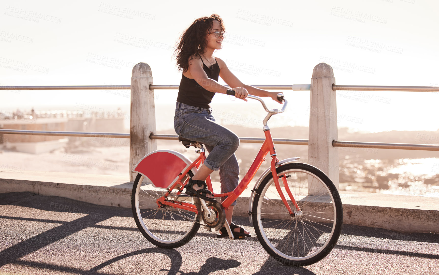 Buy stock photo Woman, cycling and bike at beach for travel with freedom, sea and sunshine with eco friendly journey in Los Angeles. Bicycle, exercise and adventure by the coast, carbon footprint and sustainability