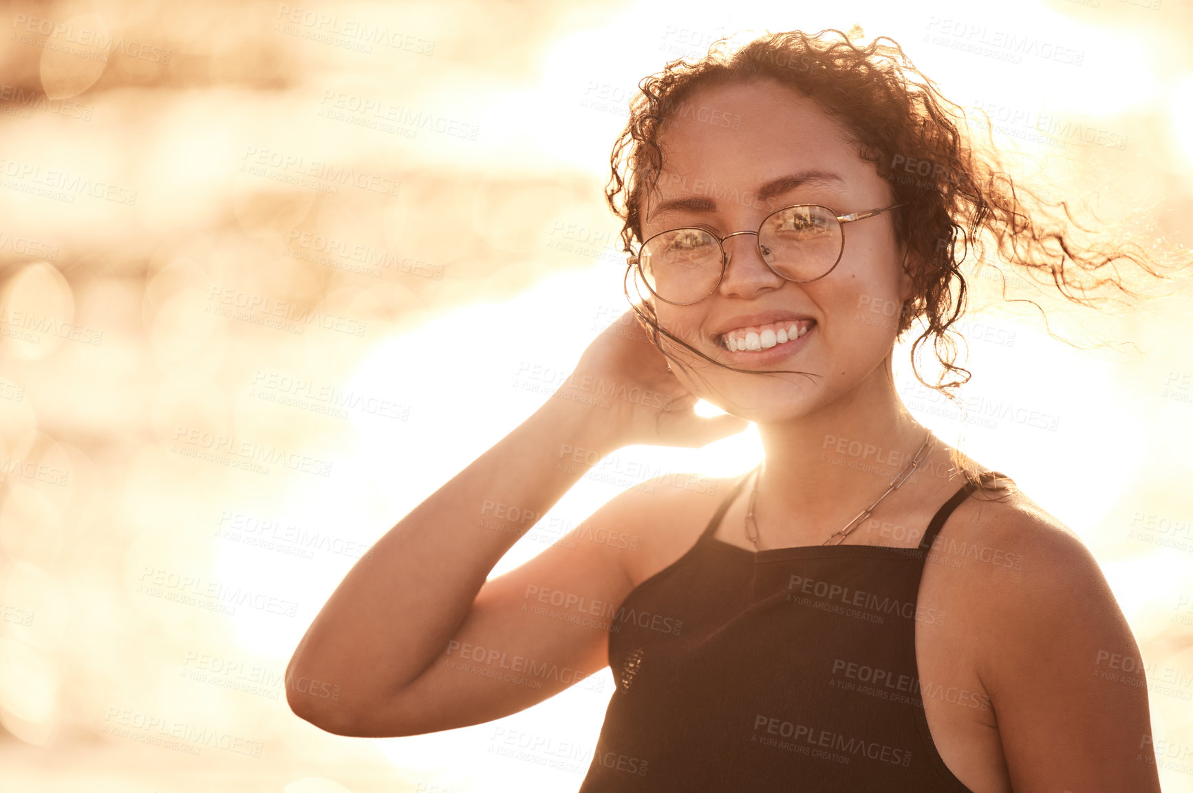 Buy stock photo Portrait, beach and travel with woman, sunshine and summer with adventure, smile and vacation. Face, person and girl with joy, seaside and ocean with getaway trip, sunset and journey with break