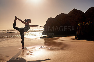 Buy stock photo Shot of a young woman practicing yoga at the beach