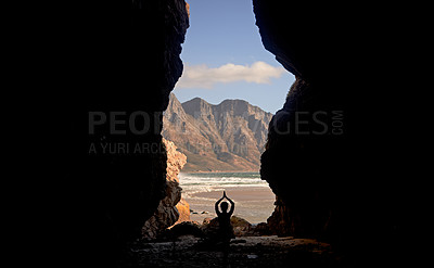 Buy stock photo Shot of a woman practising yoga while sitting in a cave overlooking the sea