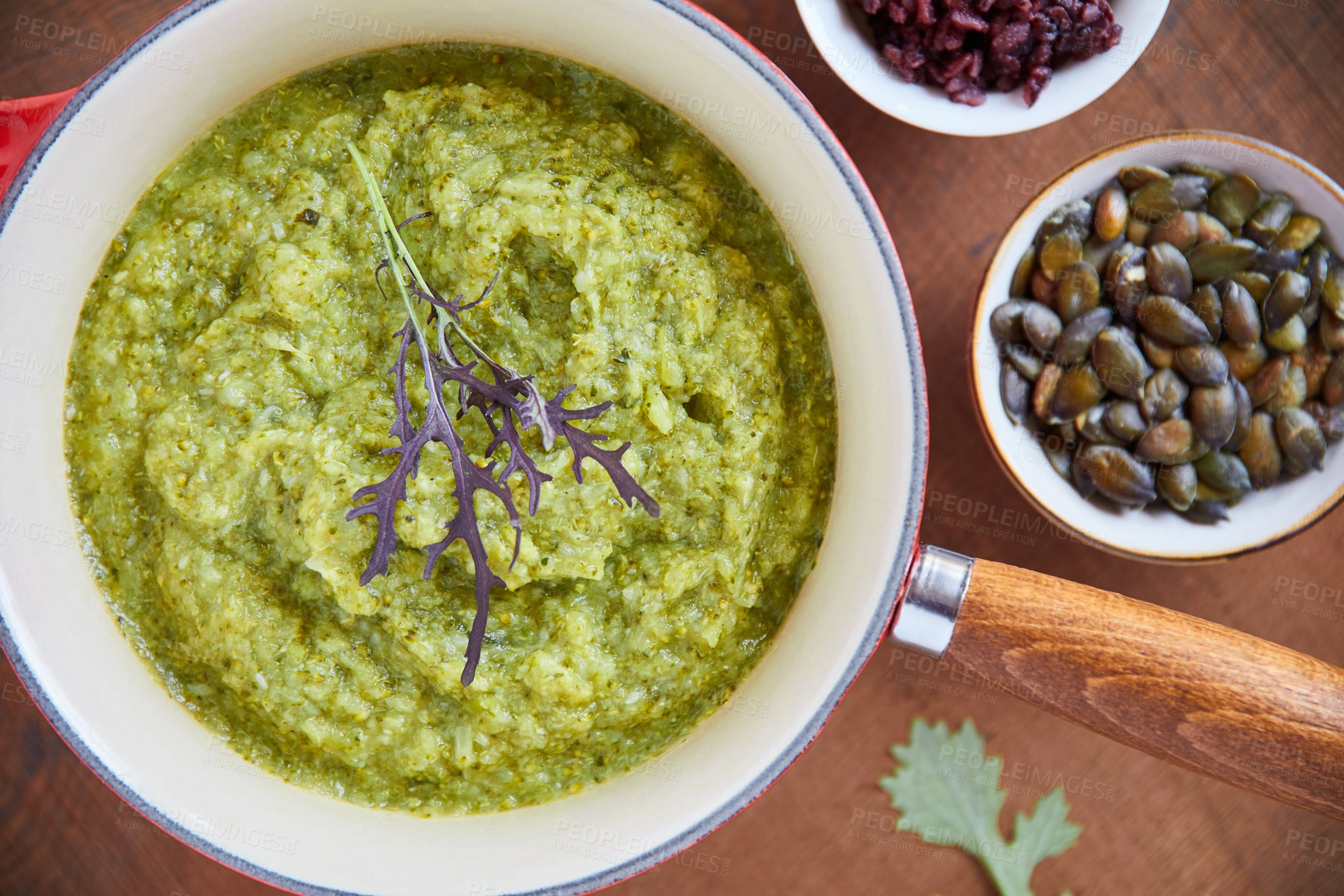 Buy stock photo Overhead shot of a pepita guacamole in a pan on a wooden table