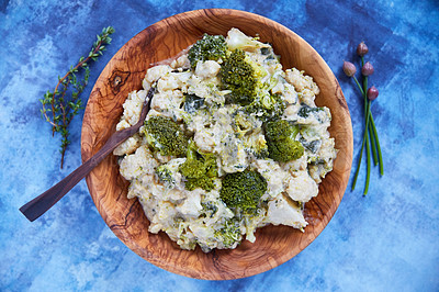 Buy stock photo Overhead shot of cauliflower and broccoli mash in a wooden serving bowl on a blue background