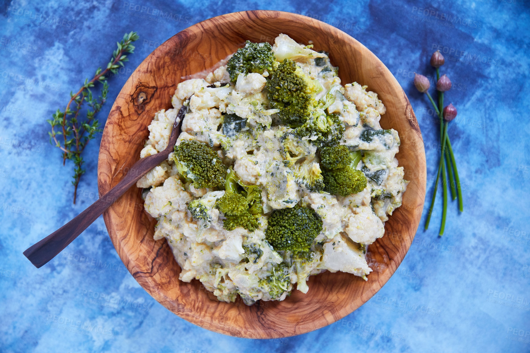 Buy stock photo Overhead shot of cauliflower and broccoli mash in a wooden serving bowl on a blue background