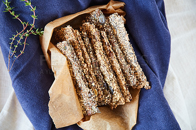 Buy stock photo Overhead shot of seed crackers in a brown paper bag on a blue tablecloth