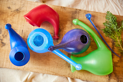 Buy stock photo Overhead shot of colourful gravy boats on a wooden board