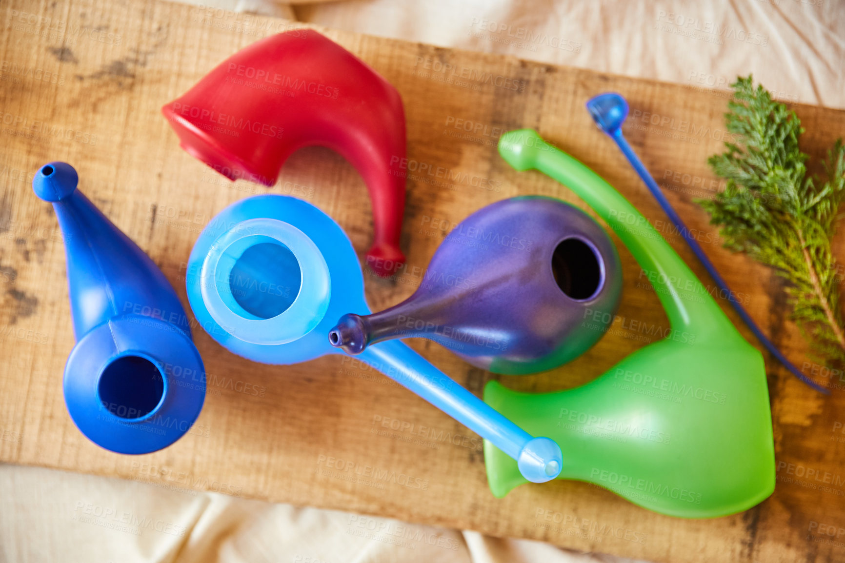 Buy stock photo Overhead shot of colourful gravy boats on a wooden board