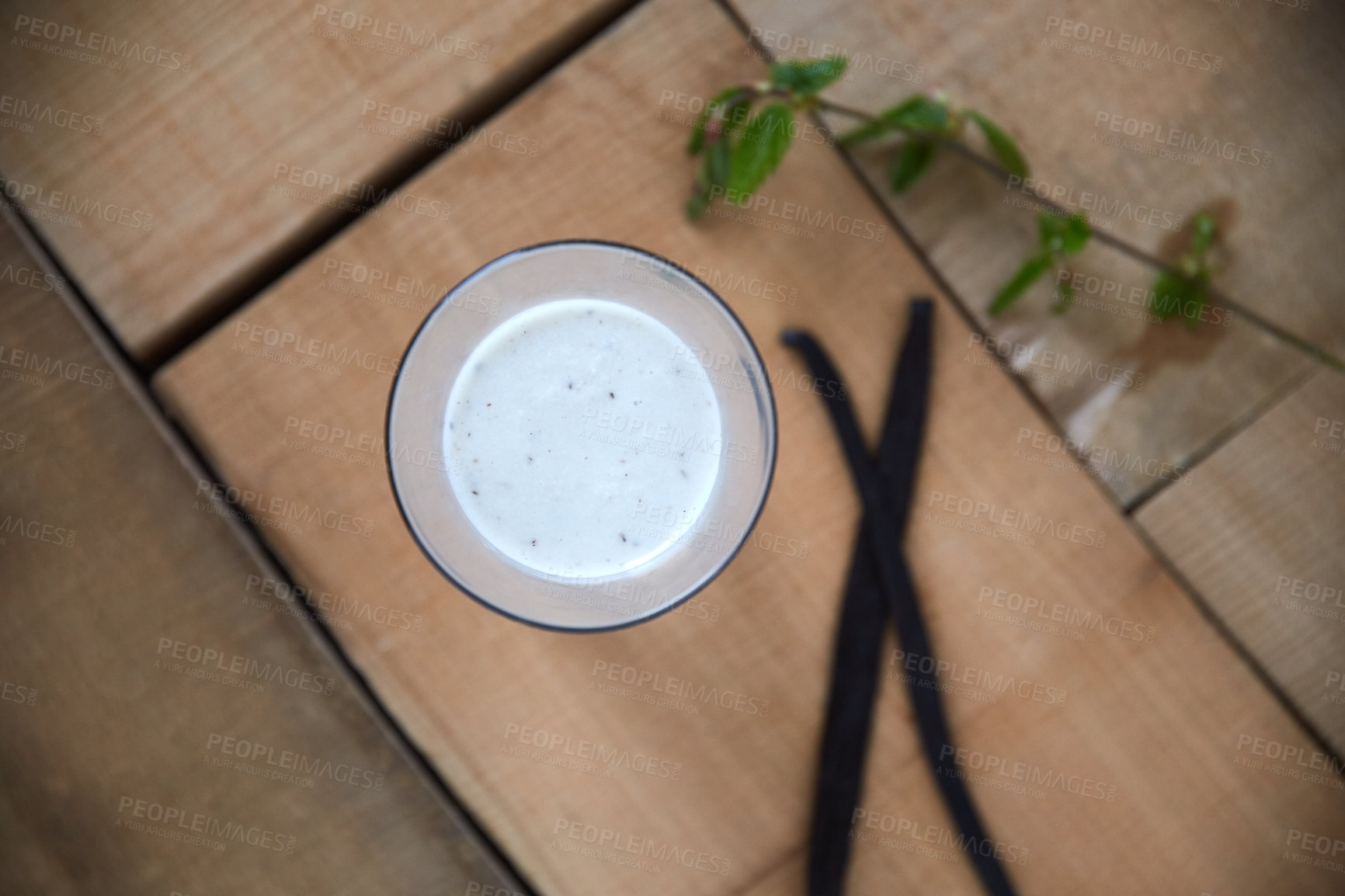 Buy stock photo Overhead shot of a vanilla smoothie on a wooden table