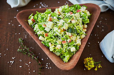 Buy stock photo Overhead shot of a chopped green salad in a wooden serving bowl