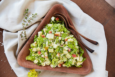 Buy stock photo Overhead shot of a chopped green salad in a wooden serving bowl