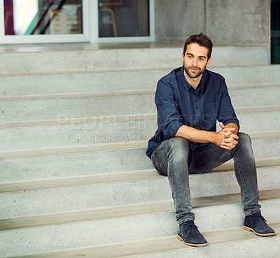 Buy stock photo Full length shot of a handsome young businessman sitting alone on a staircase during the day