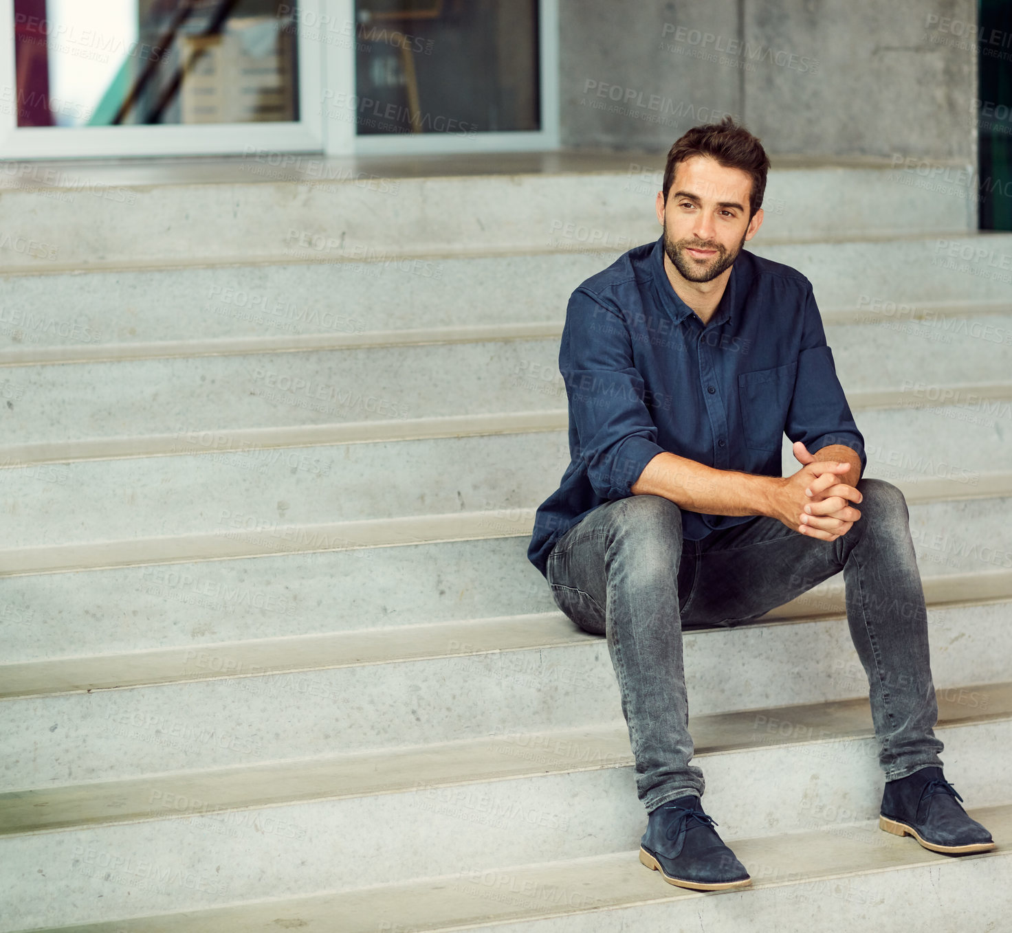 Buy stock photo Full length shot of a handsome young businessman sitting alone on a staircase during the day