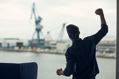 Buy stock photo Cropped shot of an unrecognizable businessman standing in an airport terminal and celebrating with his fist in the air