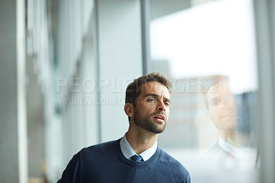 Buy stock photo Cropped shot of a handsome young businessman standing alone and looking confused