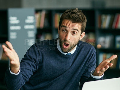 Buy stock photo Cropped shot of a handsome young businessman sitting in a library alone and looking shocked while using his laptop