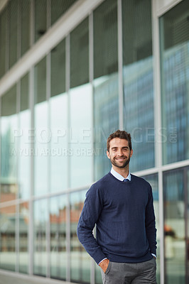 Buy stock photo Cropped portrait of a handsome young businessman standing alone outside during the day