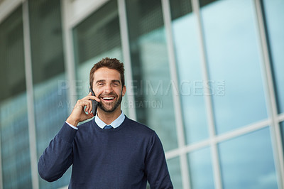 Buy stock photo Cropped shot of a handsome young businessman standing alone outside and using his cellphone during the day