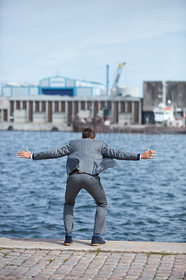 Buy stock photo Full length shot of an unrecognizable businessman standing on the dock and wanting to jump into the water