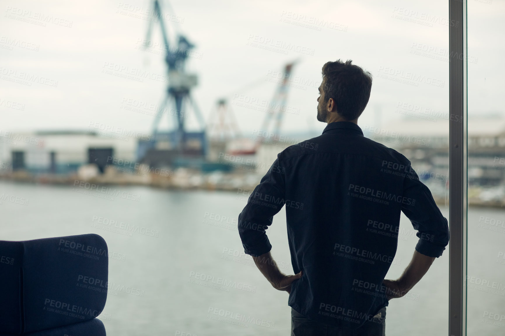 Buy stock photo Cropped shot of an unrecognizable businessman standing alone in an airport terminal during the day
