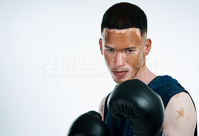 Buy stock photo Portrait shot of a handsome young male boxer with vitiligo posing in studio