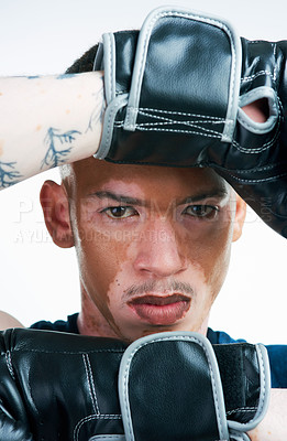 Buy stock photo Serious man, portrait and boxer with gloves or vitiligo for self defense, block or fighting technique on a white studio background. Male person or young fighter ready for MMA challenge or competition