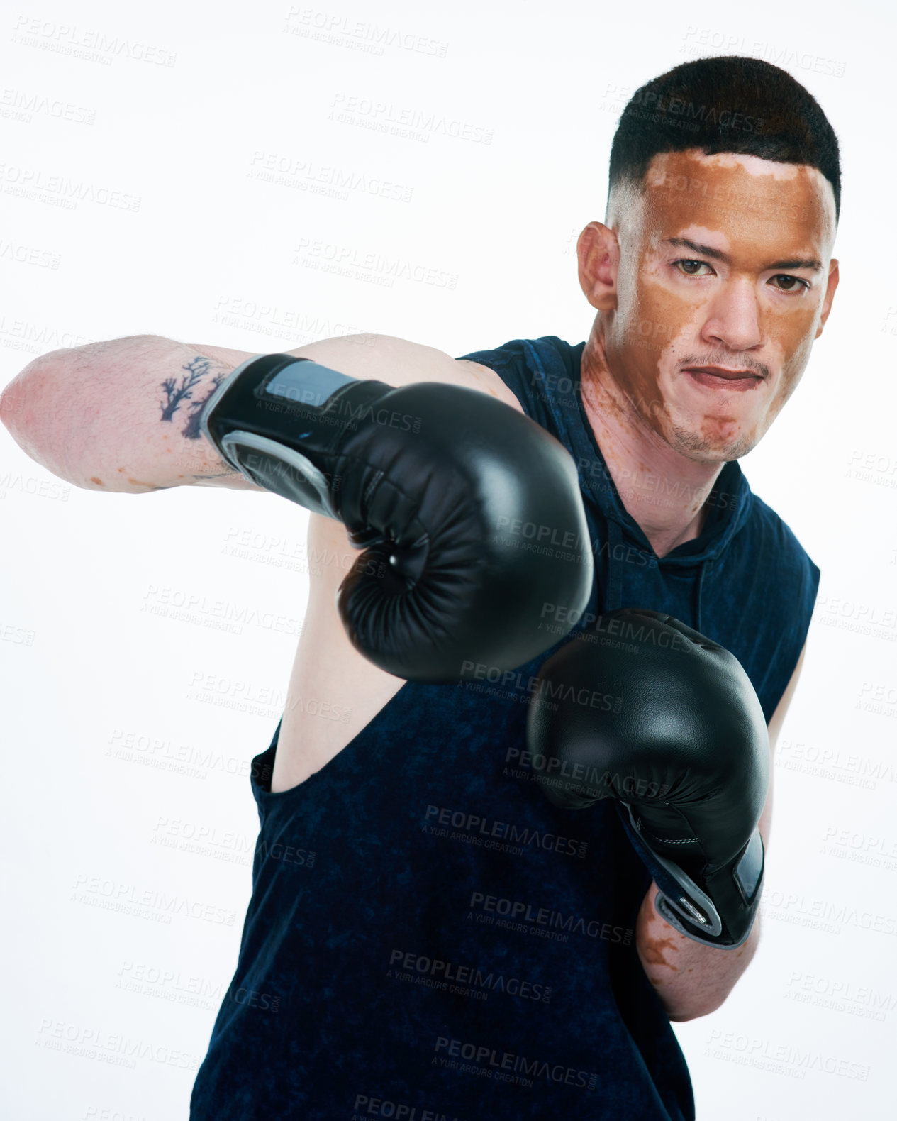 Buy stock photo Serious man, portrait and fighter with gloves or vitiligo for self defense, technique or punch on a white studio background. Male person or young boxer ready for MMA challenge, fight or competition