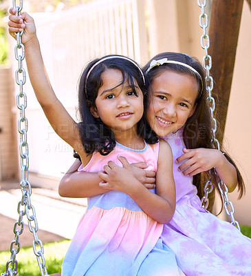 Buy stock photo Shot of two little girls sitting together on swing