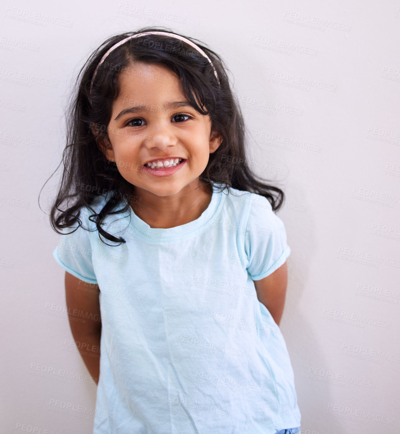 Buy stock photo Cropped shot of an adorable little girl posing against a wall