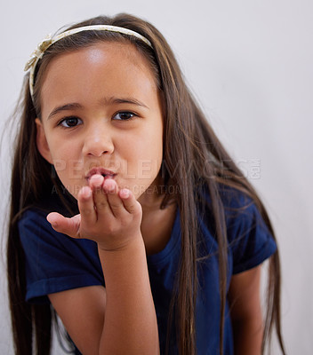 Buy stock photo Girl, kid and portrait to blow kiss for care, kindness and love with fashion by wall in family home. Child, pout lips and emoji for connection with trendy clothes, style and symbol at house in Bogota