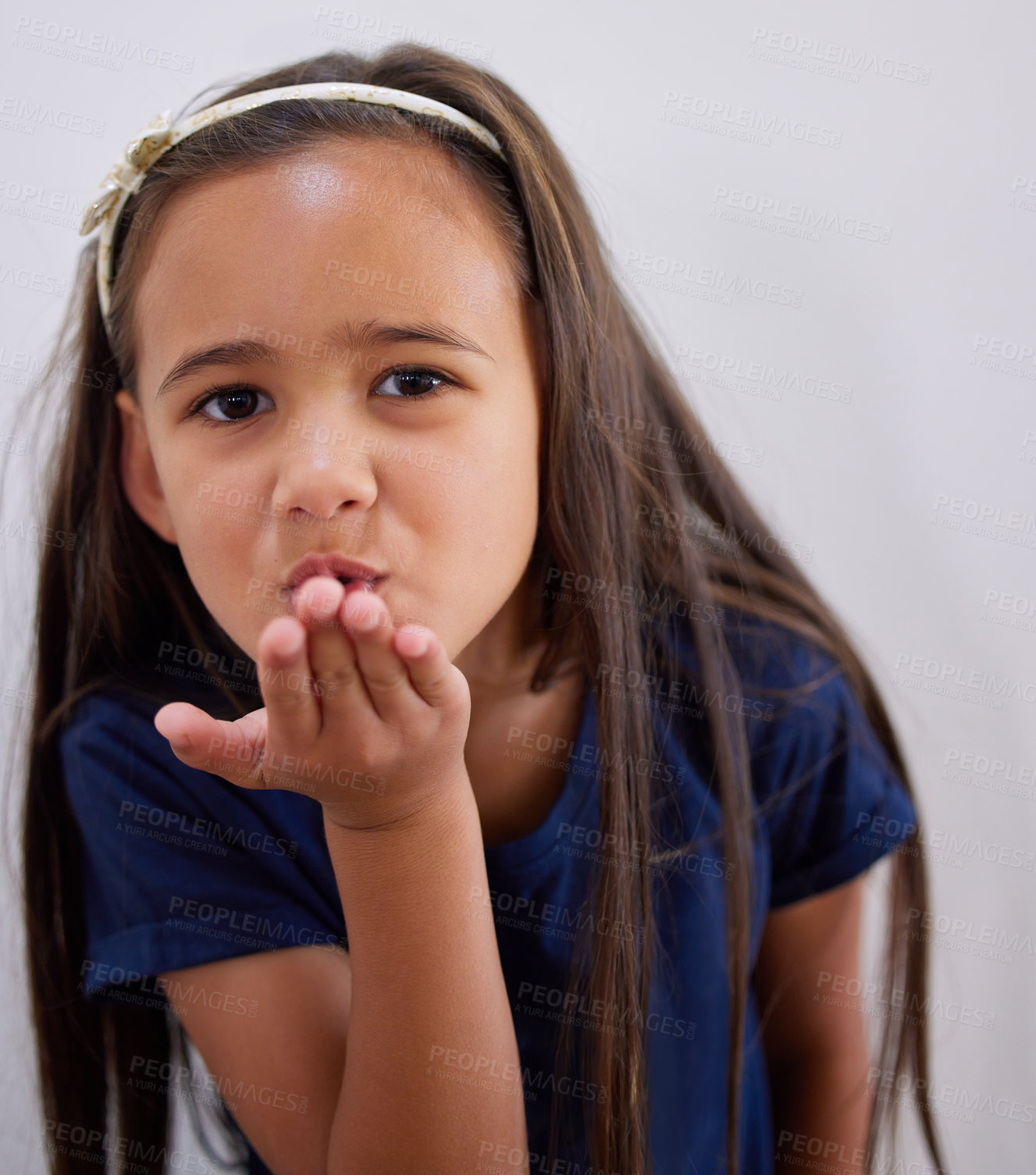 Buy stock photo Girl, kid and portrait to blow kiss for care, kindness and love with fashion by wall in family home. Child, pout lips and emoji for connection with trendy clothes, style and symbol at house in Bogota