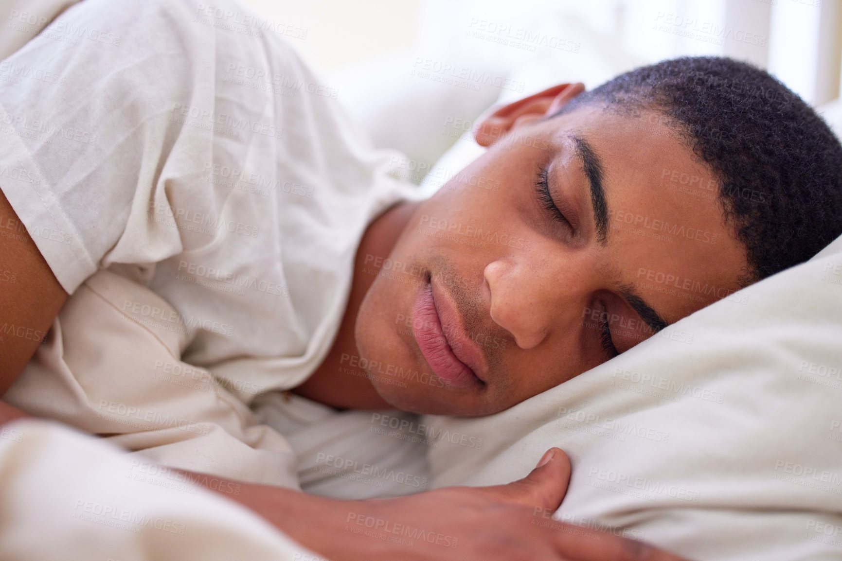 Buy stock photo Cropped shot of a handsome young man sleeping in bed during the early hours of the morning at home