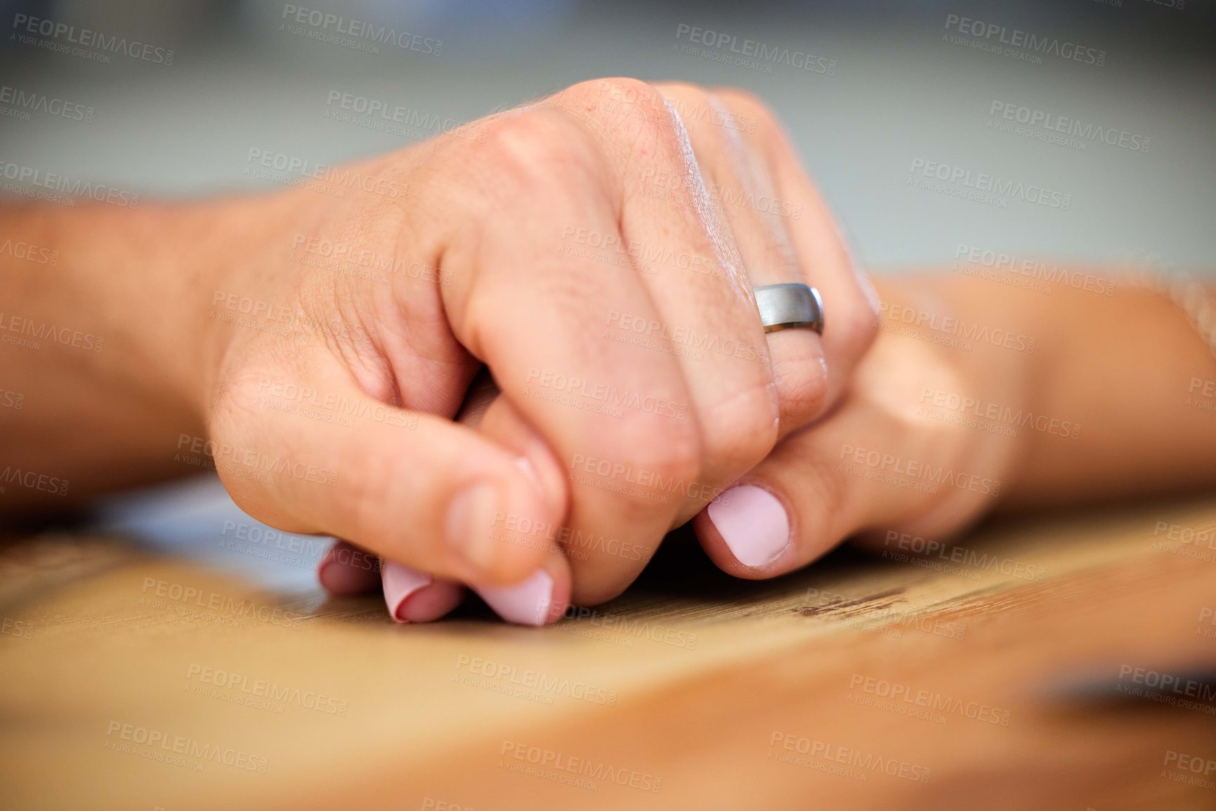 Buy stock photo Shot of an anonymous couple holding hands at home