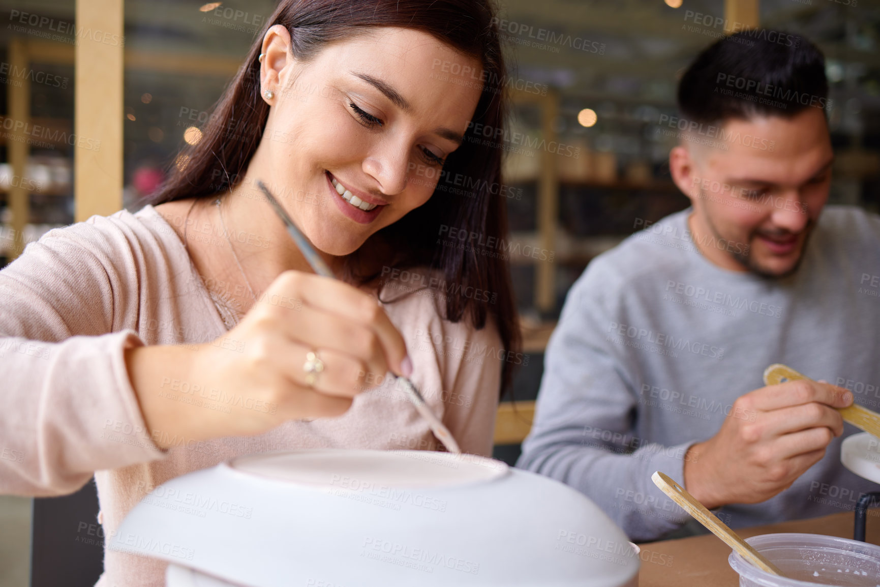 Buy stock photo Woman, man and painting ceramics for date, art workshop for bonding with paintbrush and material. Anniversary activity, craft and people at pottery lesson with watercolor for  clay bowl or creativity