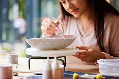 Buy stock photo Closeup, woman and painting ceramics for creativity, art workshop or class with hobby, paintbrush and material. Handmade, craft and pottery lesson with watercolor for clay bowl, design and recreation