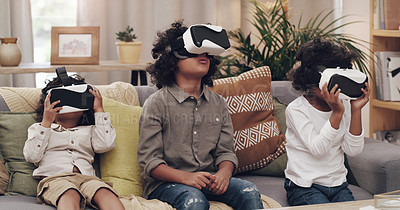 Buy stock photo Shot of three little boys watching movies together through virtual reality headsets at home