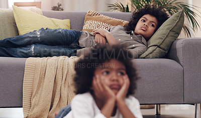 Buy stock photo Watching tv, child and couch in living room while bored, relaxing and resting on school holiday. Young boy, laying and comfort on sofa for cartoons, series and streaming for vacation with family