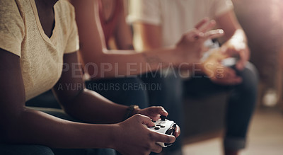Buy stock photo Shot of a group of friends playing console games at home