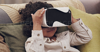 Buy stock photo Shot of a little boy watching movies together through virtual reality headsets at home