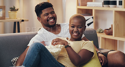 Buy stock photo Shot of a young couple relaxing on the couch in their lounge